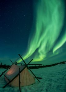 green colour Northern lights with tent